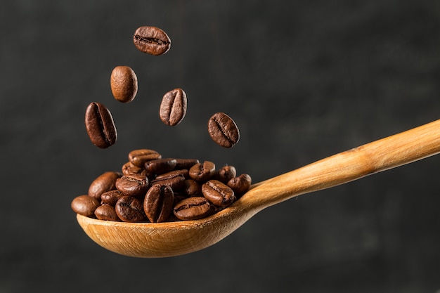 Macro falling coffee bean on gray background