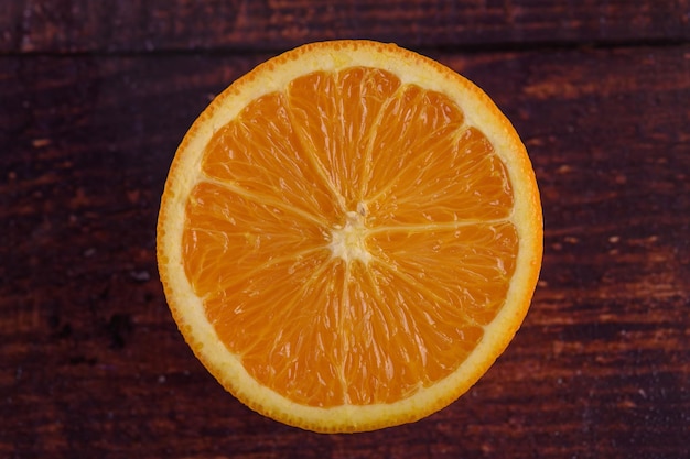 Macro image of ripe orange on wood background