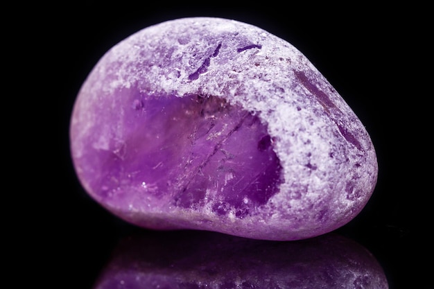 Macro mineral amethyst on a black background