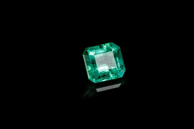 Macro mineral Emerald gemstone faceted on black background