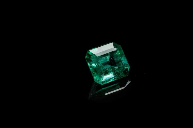 Macro mineral Emerald gemstone faceted on black background