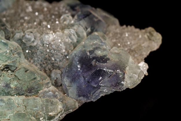 Macro mineral fluorite stone on black background