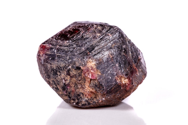 Macro of a mineral garnet stone on a white background