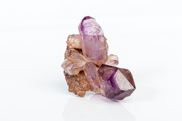 Macro mineral stone Amethyst on smoky quartz on a white background