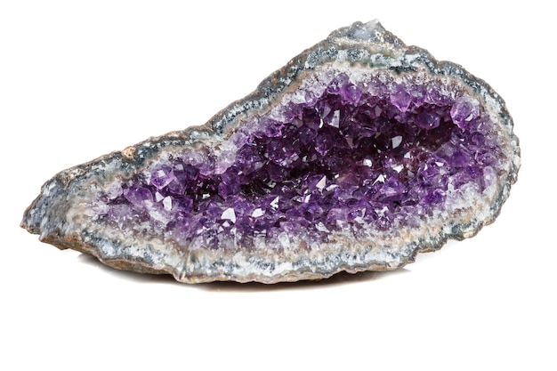 Macro Mineral Stone Amethysts in the rock on a white background