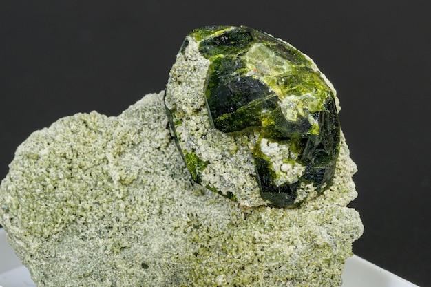 Macro mineral stone Andradite on a black background