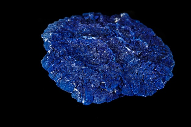 Macro mineral stone Azurite in siltstone against black background