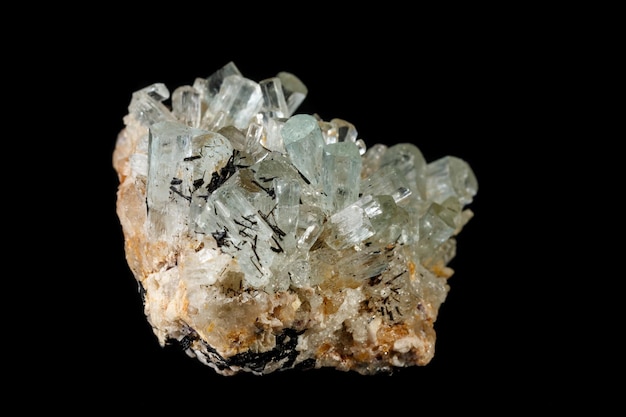 Macro mineral stone crystals Aquamarine in rock on a black background