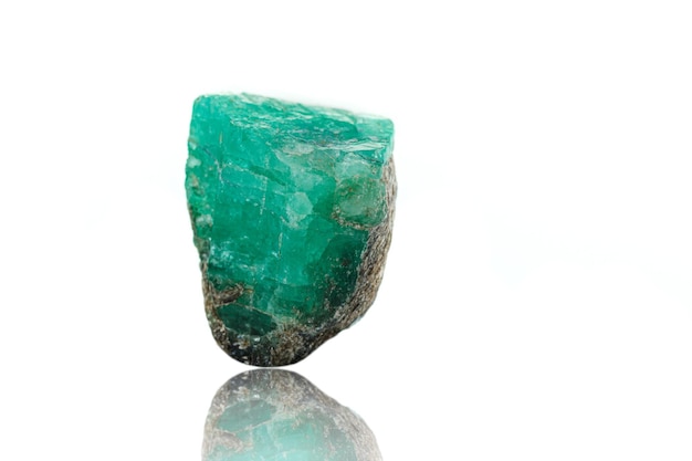 Macro mineral stone emerald on a white background