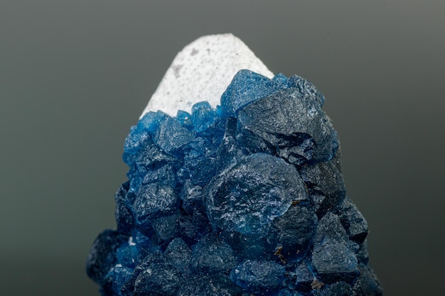 Macro mineral stone Fluorite on quartz on a gray background