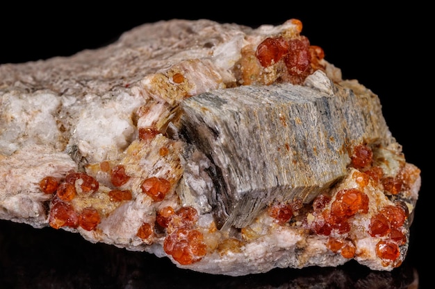 Macro mineral stone Grossular Garnet Epidote on a black background