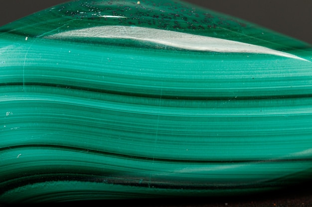 Macro mineral stone malachite on a black background