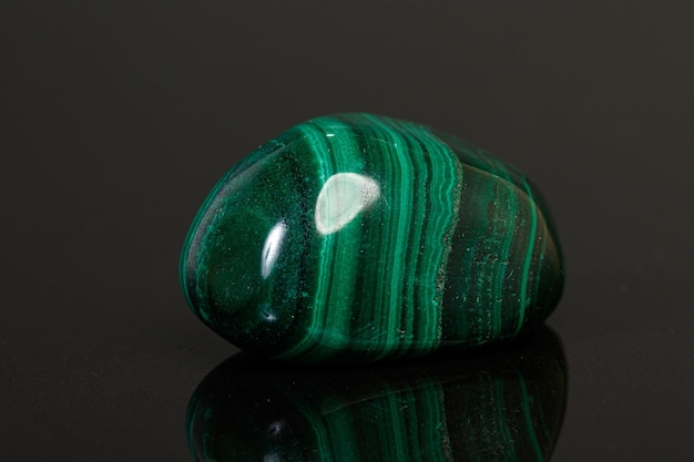 Photo macro mineral stone malachite on a black background