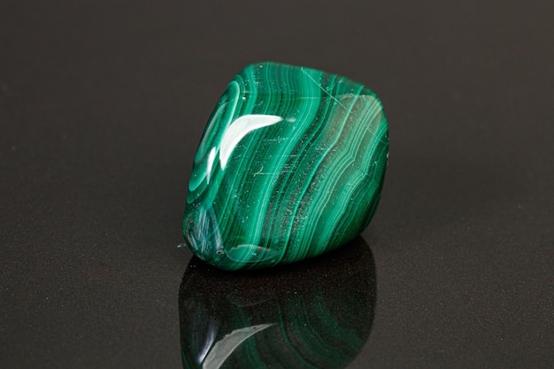 Macro mineral stone malachite on a black background