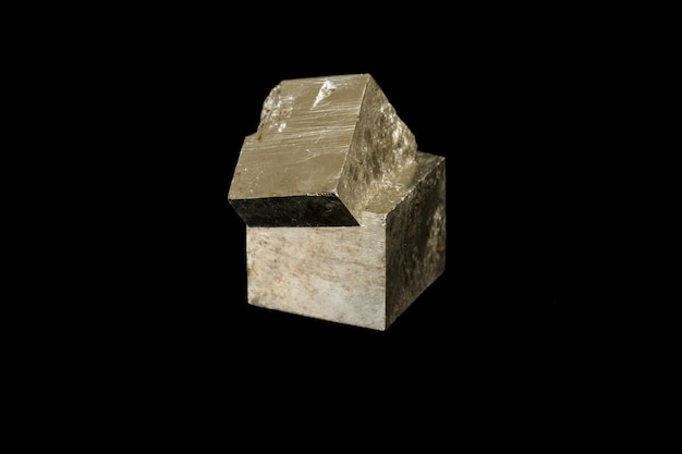 Macro mineral stone Pyrite on a black background