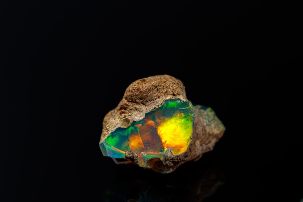 Macro mineral stone rare and beautiful opals on a black background