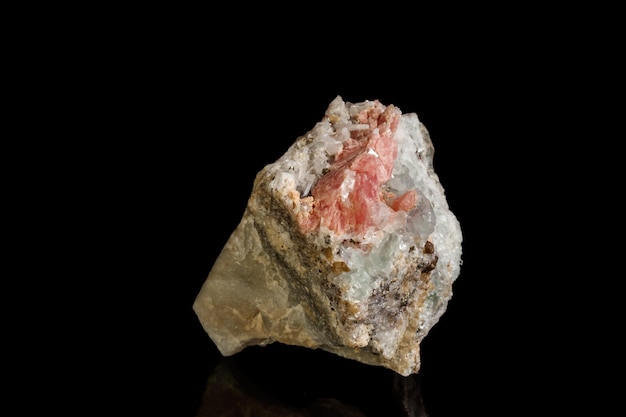 Macro of the mineral stone Rhodochrosite with fluorite on a black background