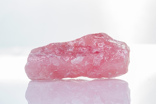 Macro mineral stone rose quartz on a white background