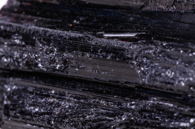 Macro mineral stone sherle schorl black tourmaline on white background