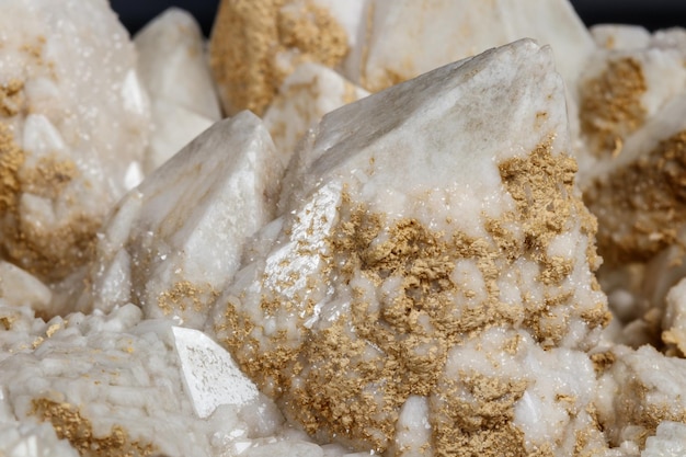 Photo macro mineral stone snow quartz with calcite on a black background