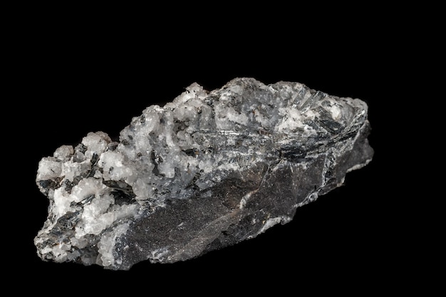 Macro mineral stone Stibnite quartz on a black background