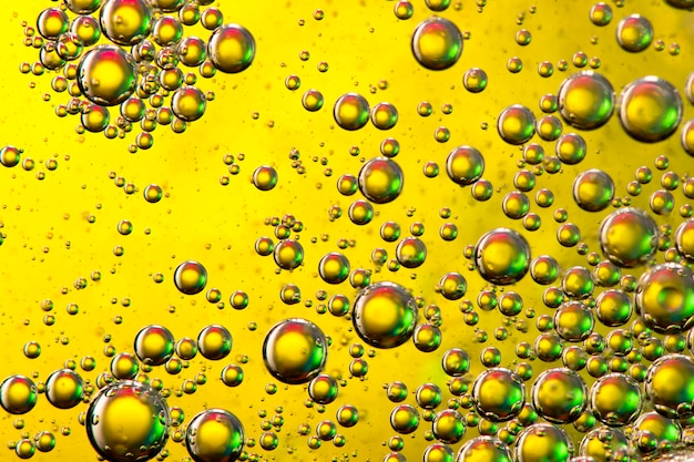 macro of oil mixed with water on colorful gradient background