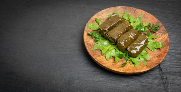 Macro Photo of Traditional Turkish Dolma, Sarma or Dolmades on Wooden Plate.