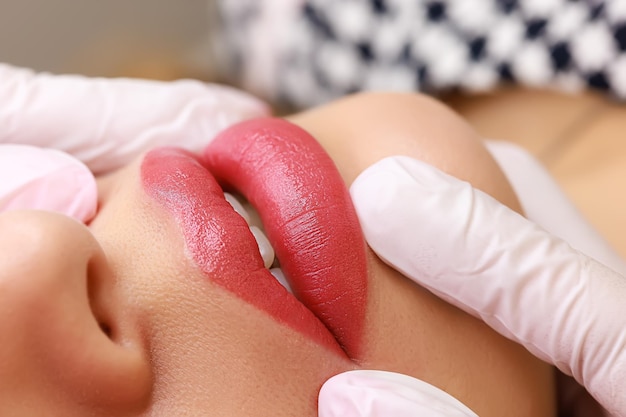 Macro photography of permanent lip makeup made with red pigment