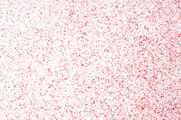 Macro photography of red spray paint on white paper