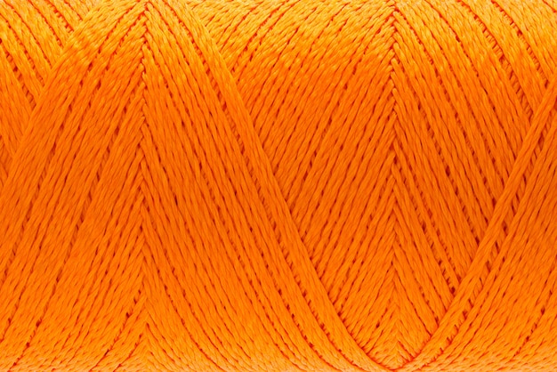 Macro picture of thread texture orange color background