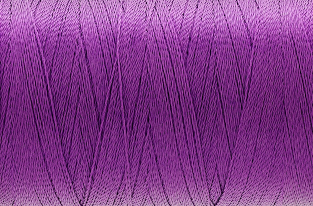 Macro picture of thread texture violet color background