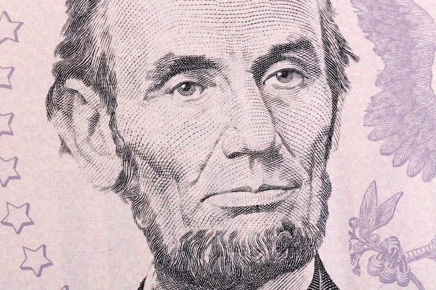 Macro portrait of Abraham Lincoln on five U.S. dollar bill. High resolution photo.