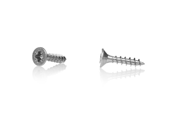 Macro screw of silver color on a white background