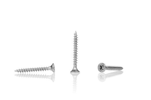 Macro screw of silver color on a white background