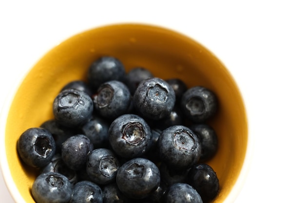 a macro selective focus blackberries in a bright yellow bowl