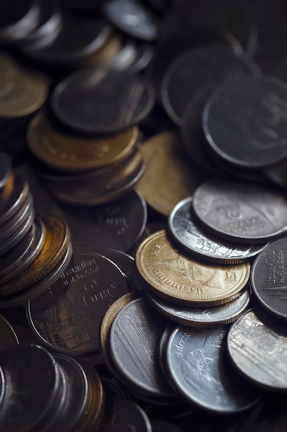 Macro shot of a large quantity of Thai baht coinsSaving glass jar Saving money concept on white background exchange investment as concept