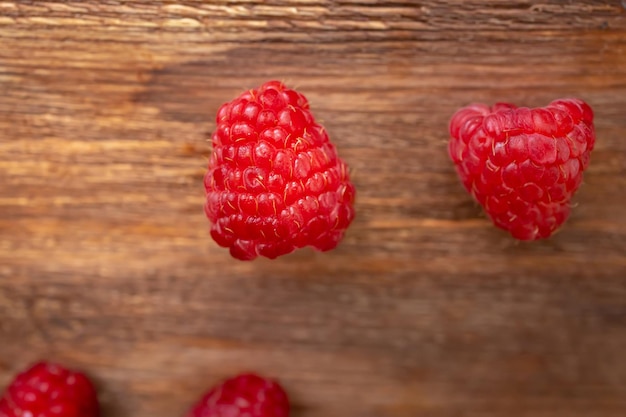 Macro shot of a raspberry that lies on a wooden table