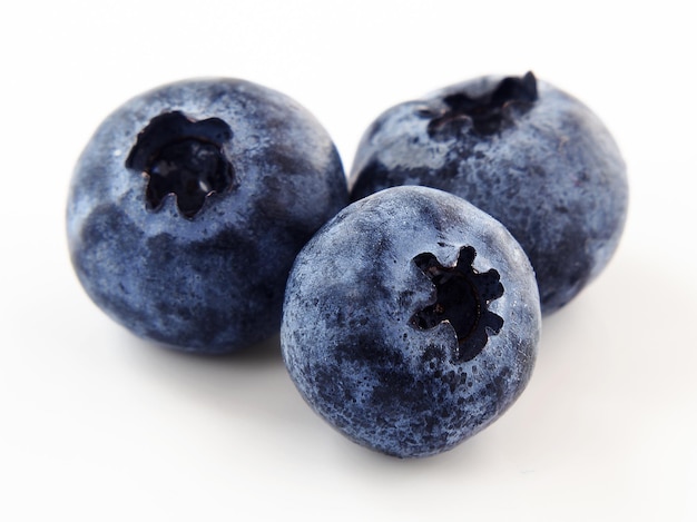 Macro shot of three blueberries isolated on a white background