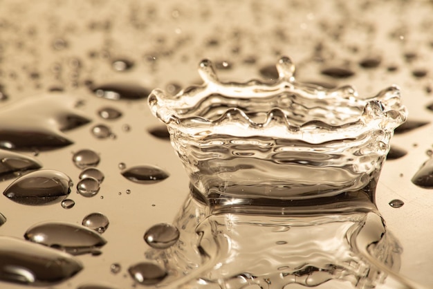 Macro splash macro photo of a drop of water falling on a reflective surface selective focus