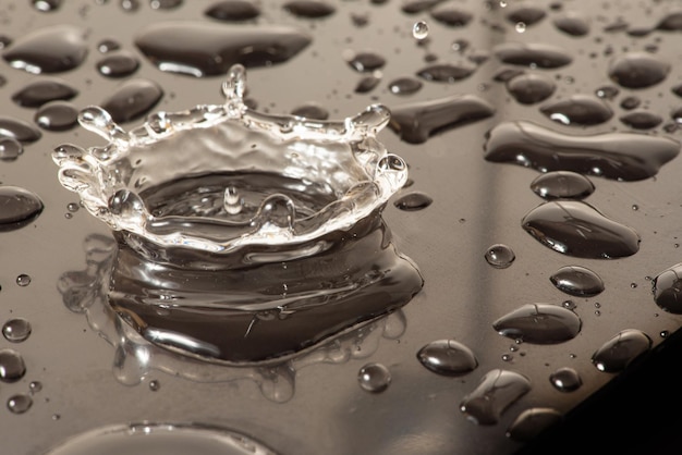 Macro splash macro photo of a drop of water falling on a reflective surface selective focus