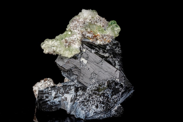 Macro stone Hyalite mineral tourmaline Sherl smoky quartz on a black background