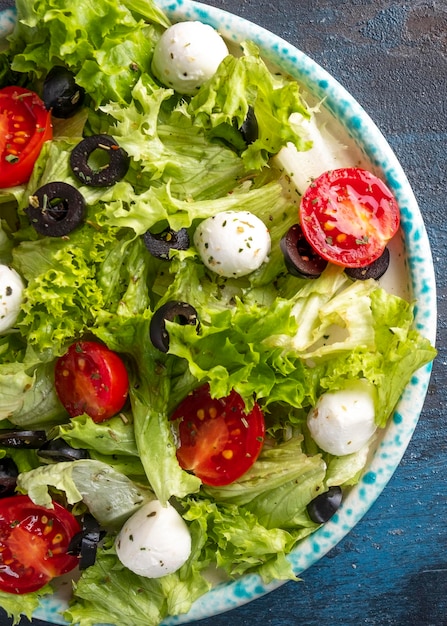 Macro view of fresh vegetables salad with tomatoes mozzarella cheese and olives