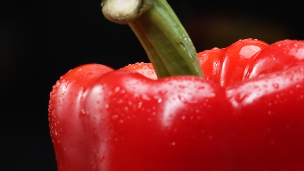 Photo macrography of a red bell pepper with black background close up comestible