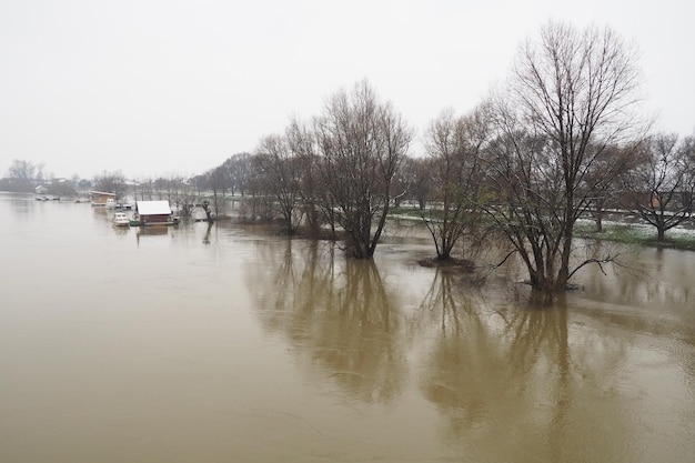 Macvanska Mitrovica Serbia 01272023 The bridge over the Sava River Flooding after heavy rains and snowmelt A swift flow of muddy water Trees boats and piers in the water Machva in winter