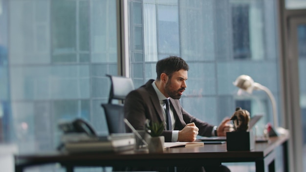 Mad entrepreneur quarrelling video meeting sitting office man shouting laptop