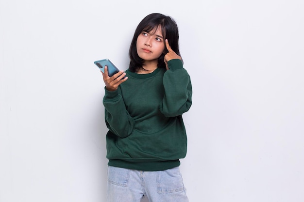 mad and shock young asian beautiful woman using mobile phone isolated on white background