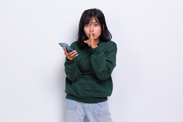 mad and shock young asian beautiful woman using mobile phone isolated on white background