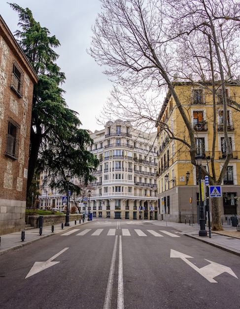 Madrid street with neoclassical buildings of different colors and typical balconies. Spain.