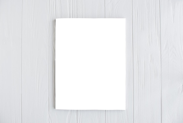 Photo magazine cover mockup on white wooden table