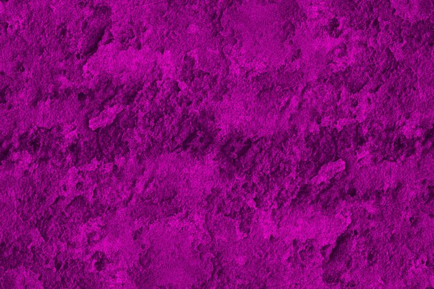 Magenta color old concrete wall surface with rough grunge texture